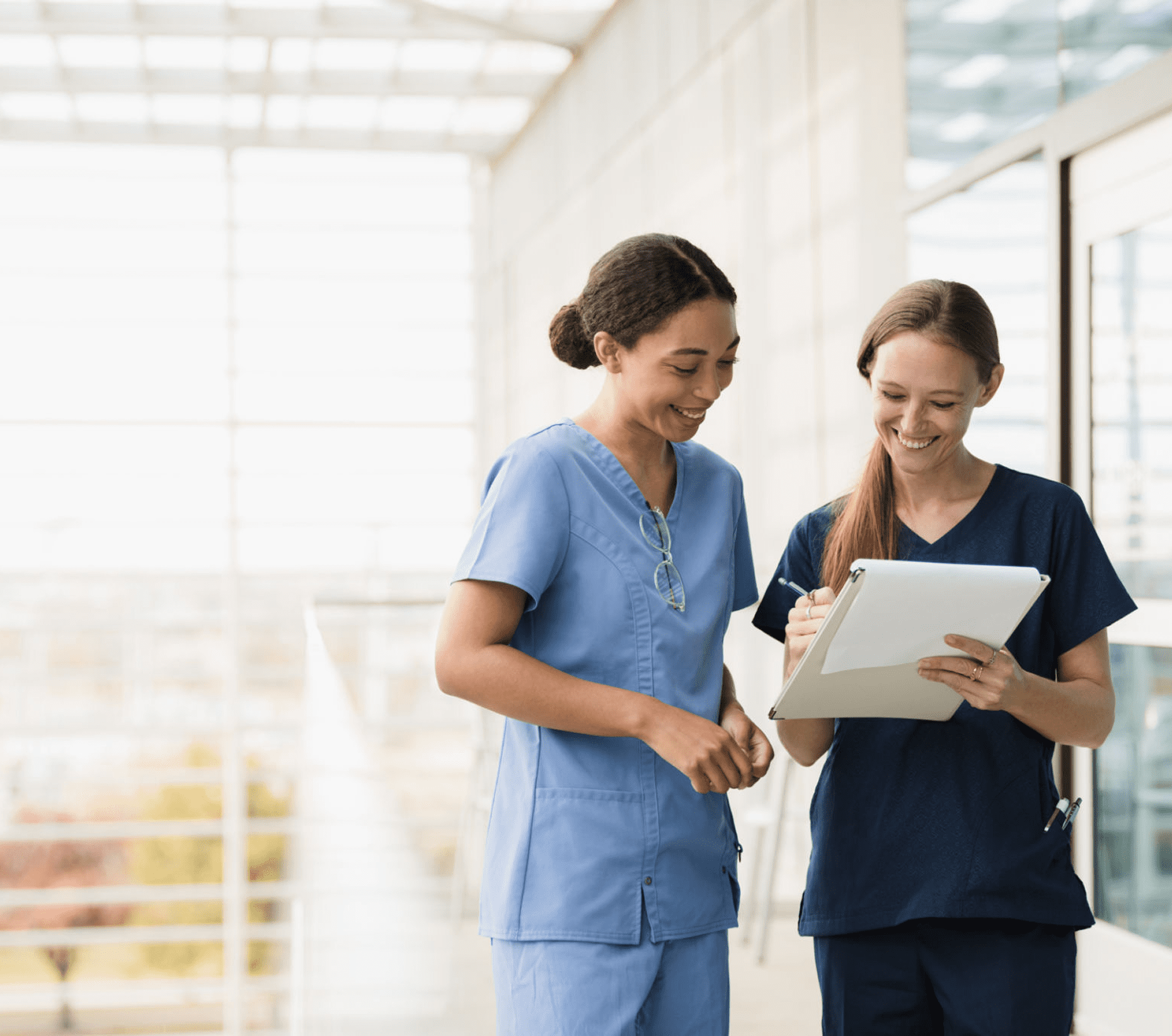 Two nurses discussing patient notes