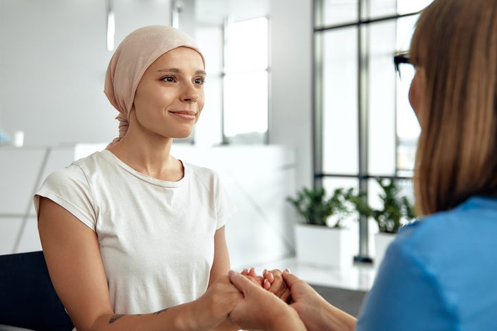 A truly heartwarming moment shared between a patient in a wheelchair and their dedicated caregiver, beautifully showcasing the deep compassion and unwavering support found within a healthcare setting
