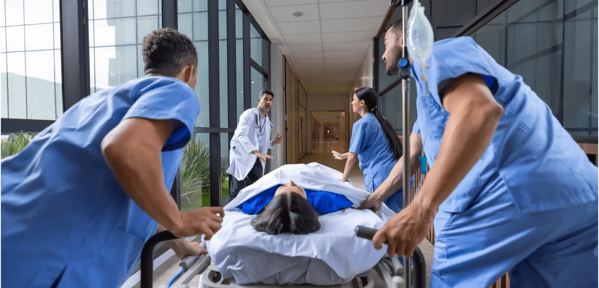 Medical team rushing patient down hallway